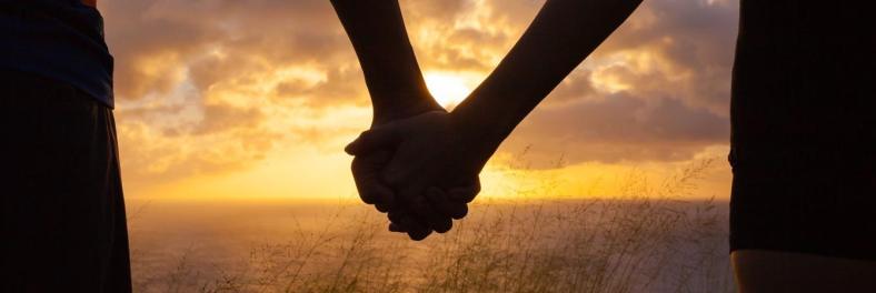 romance-couple-holding-hands-by-water.jpg.1340x450_0_166_6978